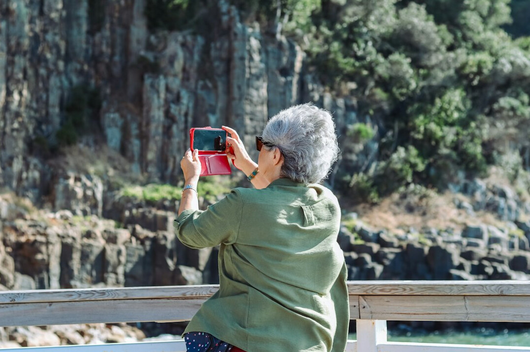 Senior woman looking at family photos on a tablet
