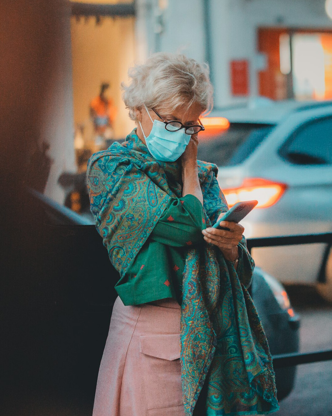 Senior woman reading a security notice on a smartphone with a thoughtful expression