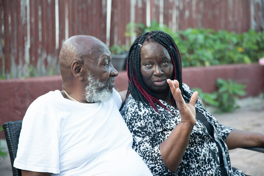 Senior man and his granddaughter looking at a smartphone together