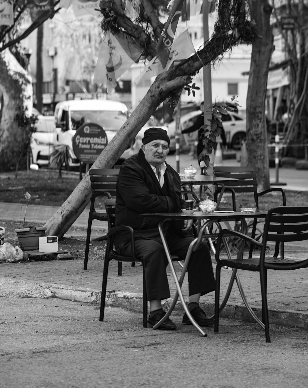 Senior woman holding a tablet and smiling at a cafe table