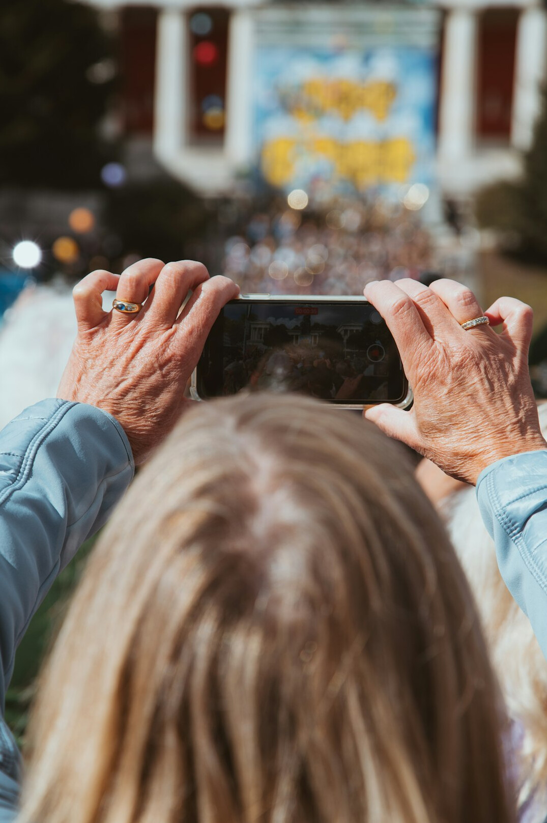 Senior hands holding a smartphone with large app icons