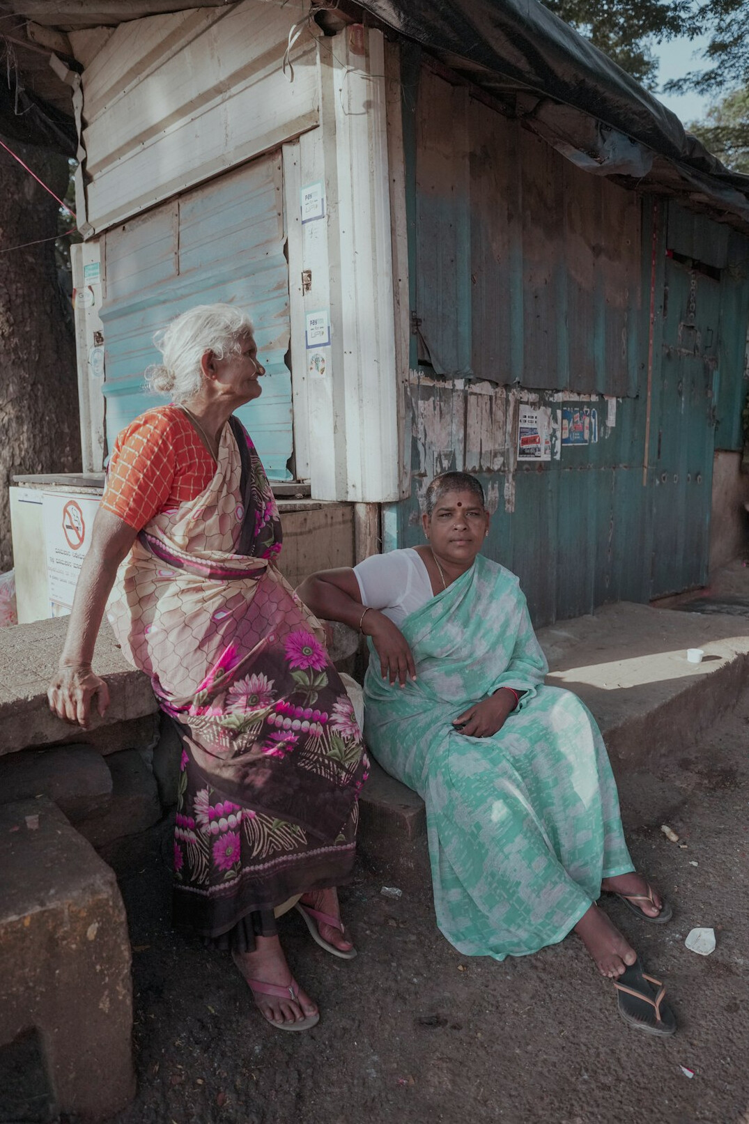 Senior woman and a younger helper looking together at a tablet screen in a calm room