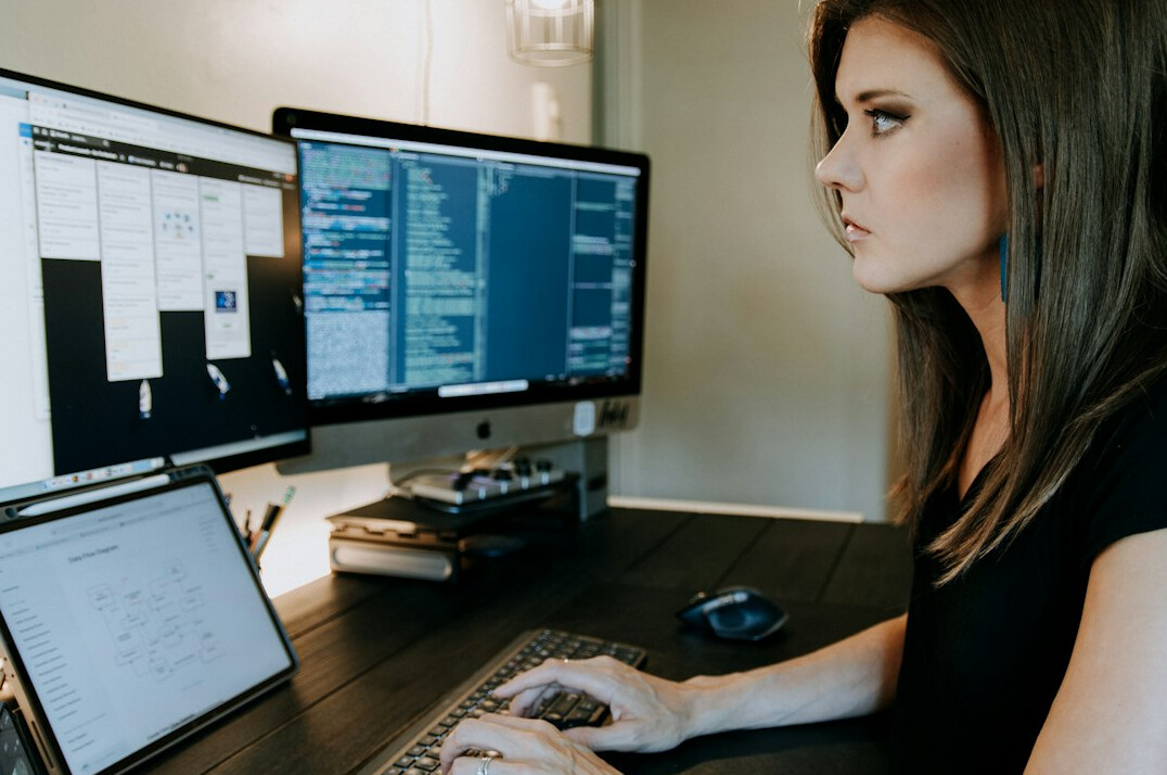 woman studying data on screen